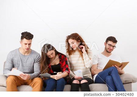 Diverse young students preparing for exam at home 30402480