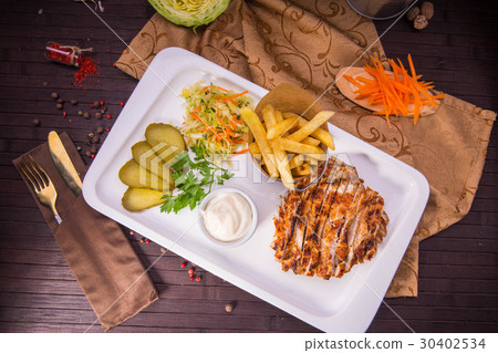 Shawarma. Slices of the fried marinated meat, are  30402534