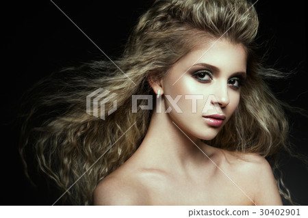 Young beautiful woman with long curly hairs 30402901