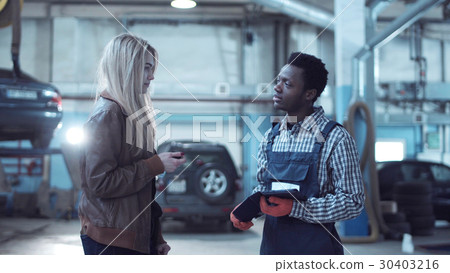 Client giving keys from car to mechanic Client giving keys from car to mechanic 30403216