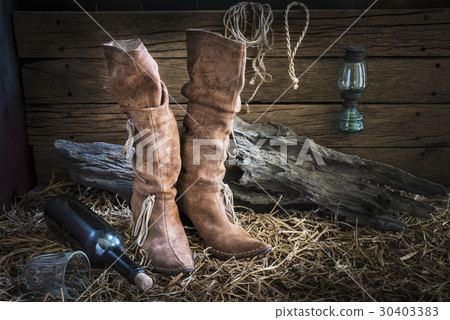 Still life with traditional leather boots in barn Still life with traditional leather boots in barn 30403383
