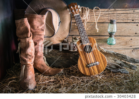 Still life with ukulele on cowboy hat and boots 30403428