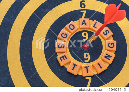 Words goals setting and dart target on bullseye 30403543