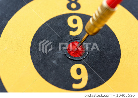 Closeup dart hitting on bullseye target Closeup dart hitting on bullseye target 30403550