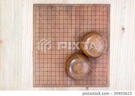 two wooden bowls over empty go game board two wooden bowls over empty go game board 30403623