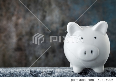 Piggy bank on stone surface 30403906