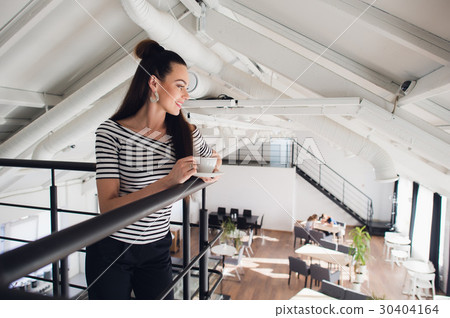 Portrait of woman standing with a cup and looking Portrait of woman standing with a cup and looking 30404164