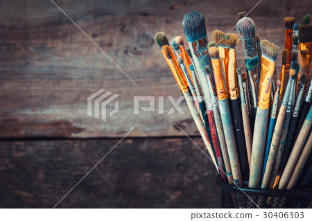 Bunch of paint brushes in a artist studio.  30406303
