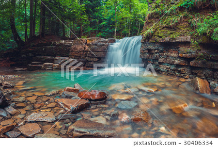 Evening waterfall in Carpathian mountains. 30406334