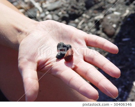 rocks in hand  near Exo Gialoso beach in Santorini 30406346