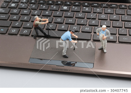 Mini workmen repairing a laptop key board. Mini workmen repairing a laptop key board. 30407745