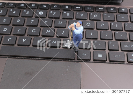 Mini workmen repairing a laptop key board. Mini workmen repairing a laptop key board. 30407757