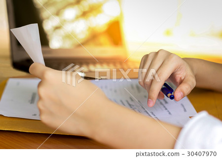 Business woman with pen reading paper document 30407970