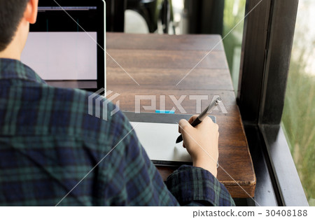 Student designer drawing on pen mouse pad  30408188