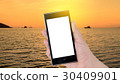 Hands holding smartphone with silhouette boat 30409901