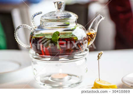 Tea with mint leaves in a glass teapot 30410869