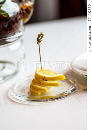 Lemon slices are on the plate. Lemon slices are on the plate. 30410870