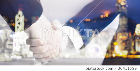 Two business men shaking hand on blurry background Two business men shaking hand on blurry background 30411559