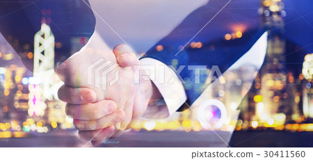 Two business men shaking hand on blurry background 30411560