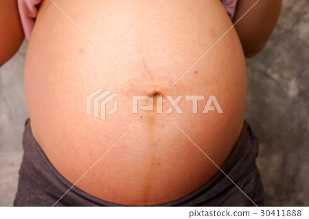 Close up of a cute pregnant belly Close up of a cute pregnant belly 30411888