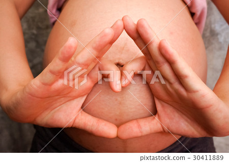 Pregnant Woman holding her hands in a heart shape Pregnant Woman holding her hands in a heart shape 30411889