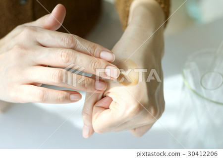 Hands applying moisturizer. cosmetic skin cream 30412206