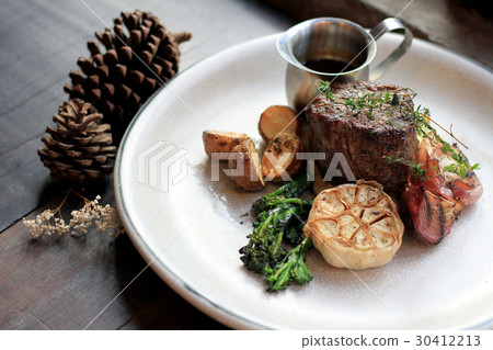 Beef rib eye steak with roasted and vegetables. 30412213