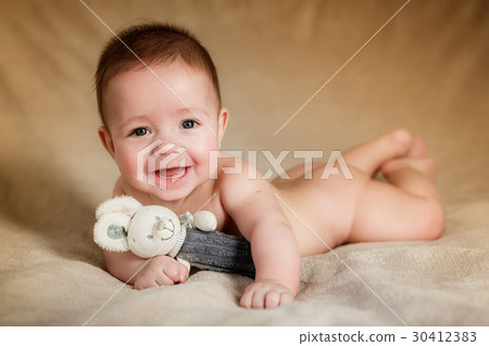 Portrait of newborn baby is lying on the blanket Portrait of newborn baby is lying on the blanket 30412383