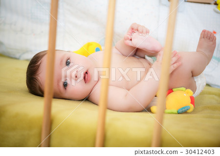 Portrait of newborn boy is lying in the bed Portrait of newborn boy is lying in the bed 30412403