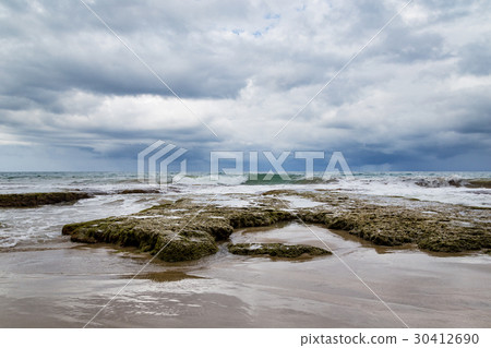 Rocky beach and coming storm Rocky beach and coming storm 30412690