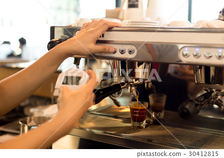 Barista making fresh espresso shot from machine  30412815