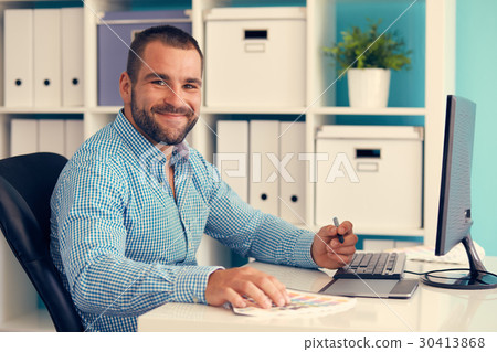 Graphic designer working on digital tablet, toned 30413868