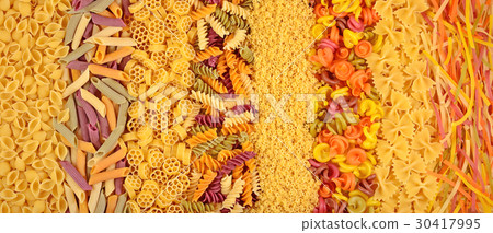 Assortment of colored uncooked Italian pasta 30417995
