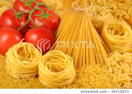 Italian pasta and ripe tomatoes branch 30418053