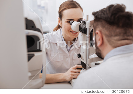 Cheerful positive doctor enjoying her job 30420675