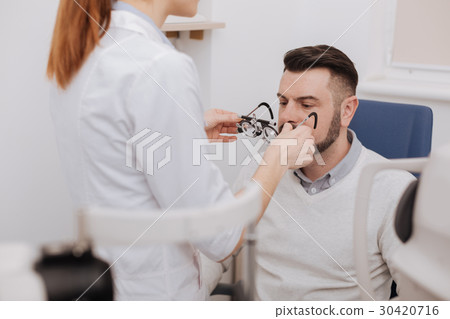 Beautiful nice optician standing in front of her 30420716