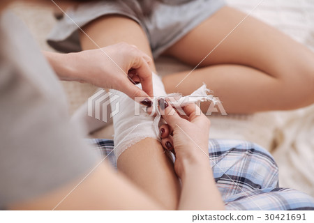 Crafty young mother providing treatment to her 30421691