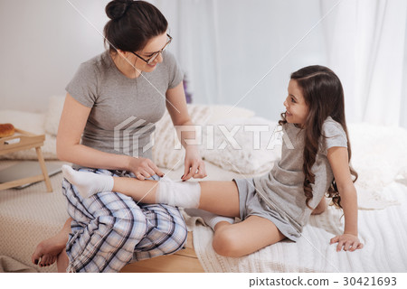 Positive young mother providing treatment to her 30421693