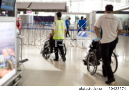 Caretaker pushing elderly people in wheelchair 30422274