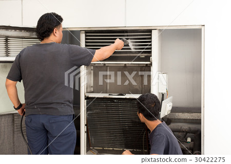 Man cleaning filter with high pressure jet pump Man cleaning filter with high pressure jet pump 30422275