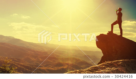 Man walking on the edge of a cliff Man walking on the edge of a cliff 30424416