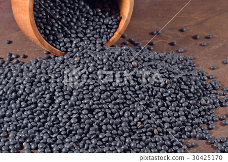 Black raw lentil in a bowl 30425170