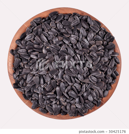 Black sunflower seeds in a wooden bowl 30425176