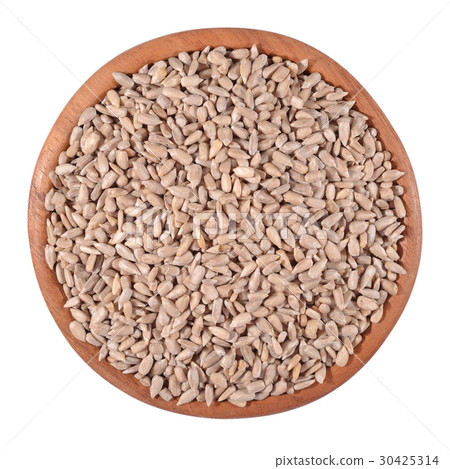 Cleared sunflower seeds in a wooden bowl on white 30425314