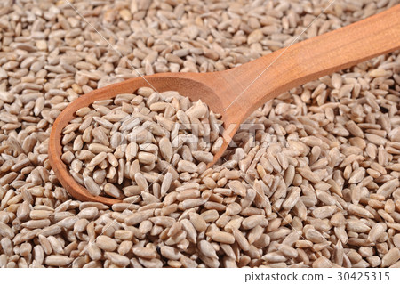 Cleared sunflower seeds in a spoon Cleared sunflower seeds in a spoon 30425315