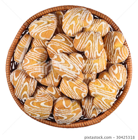 Cookies in heart shape in a wicker bowl on a white 30425318
