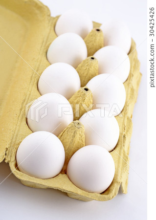 Eggs in a cardboard box on a white 30425426