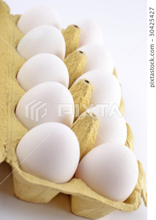 Eggs in a cardboard box on a white 30425427
