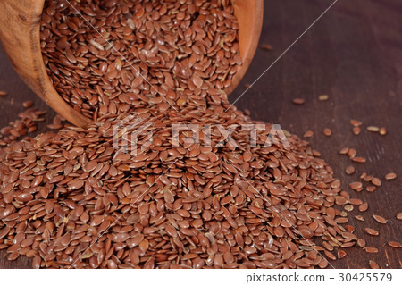 Linseed in a wooden bowl 30425579