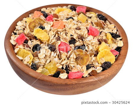 Musli in a wooden bowl on a white 30425624